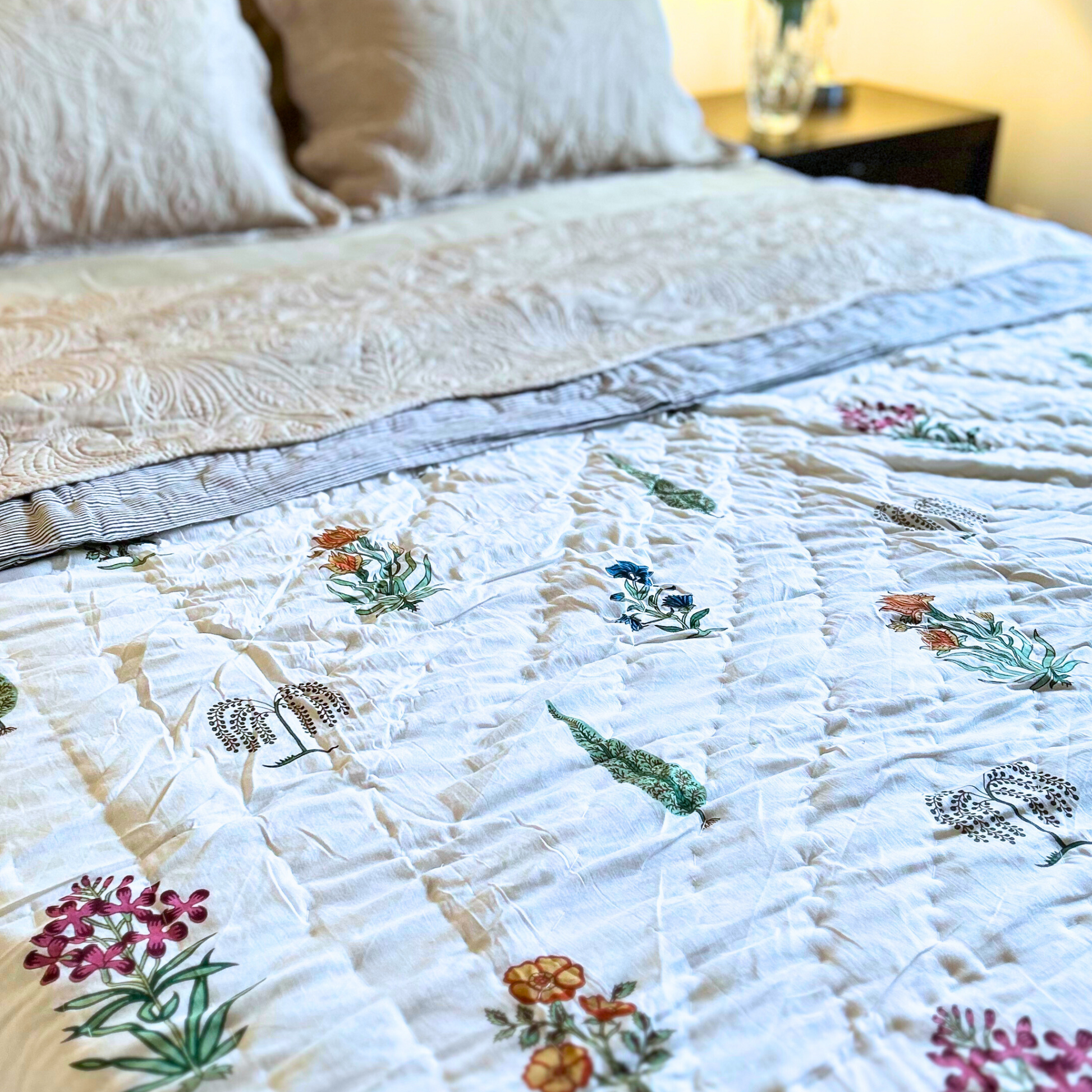 Handcrafted reversible Jaipuri block print quilt in cream.