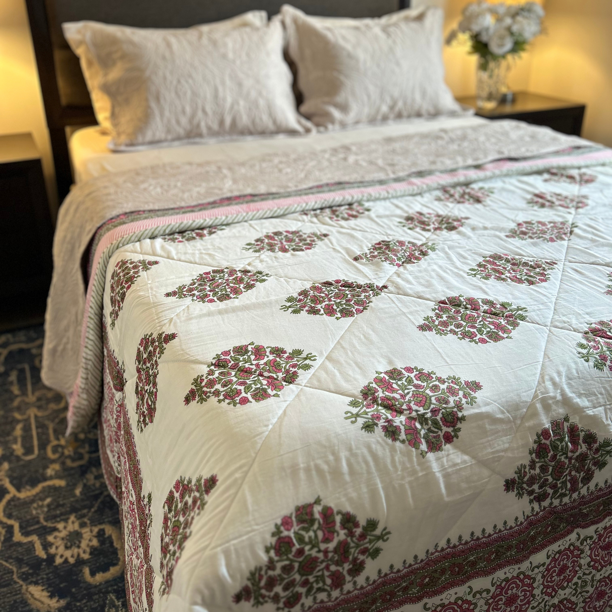 Vibrant cotton Kantha throw quilt with decorative design.