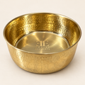 AURORA hand-hammered brass pet food bowl with the Embers Elements logo engraved inside, cream studio background