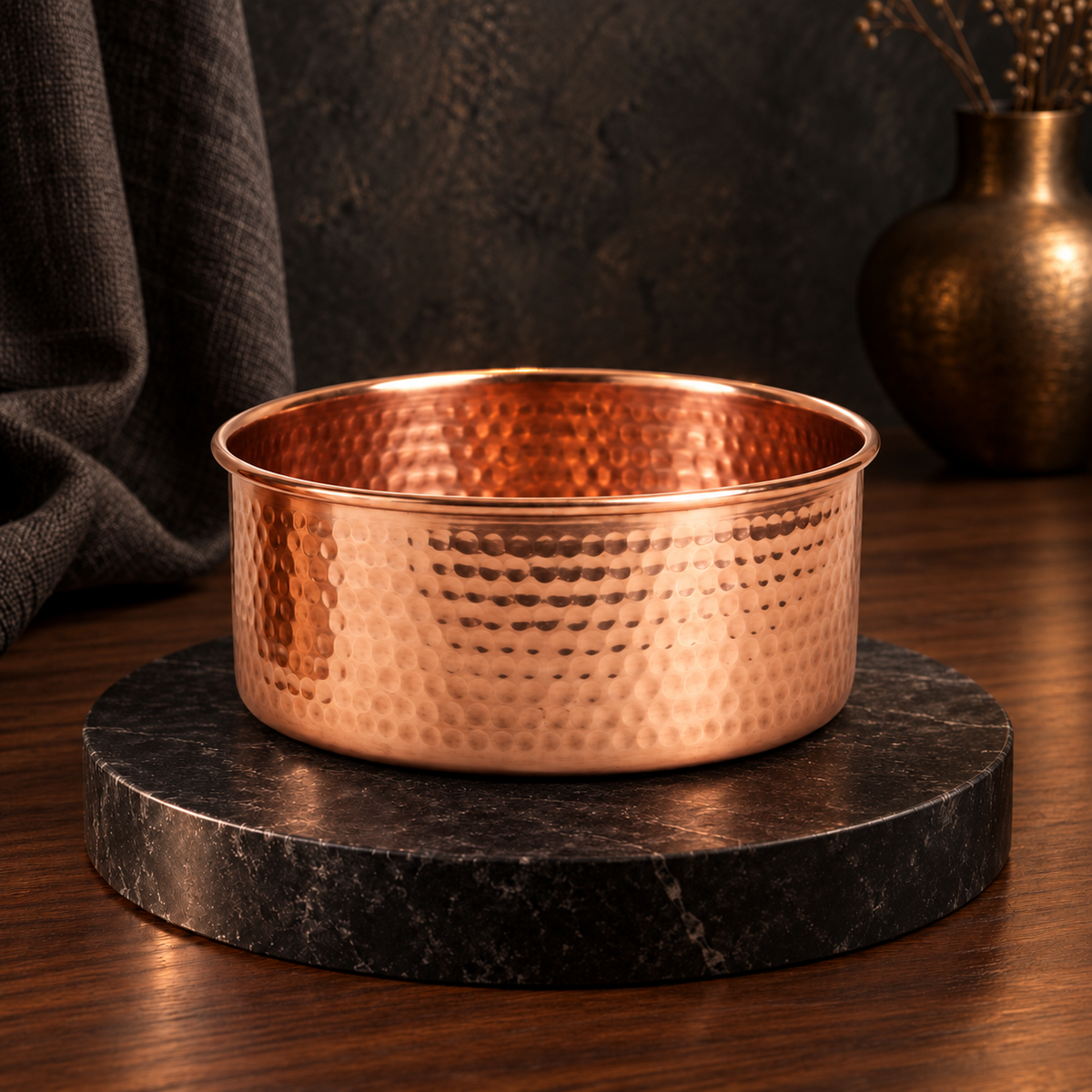AURORA hand-hammered pure copper pet water bowl displayed on a black marble stand