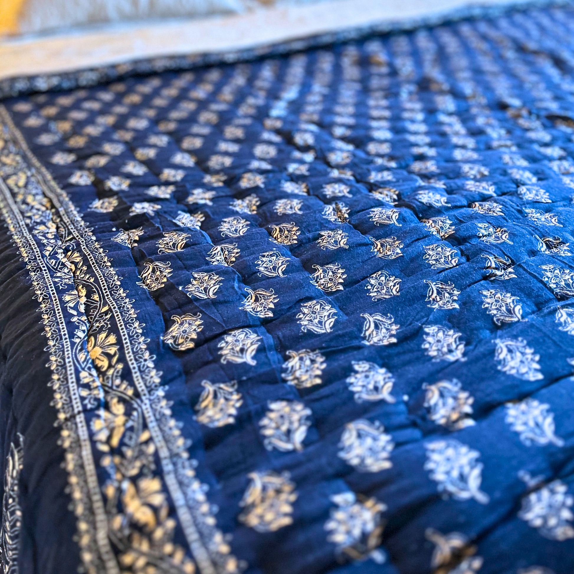 Block printed cotton quilt, Jaipuri style, in deep blue.