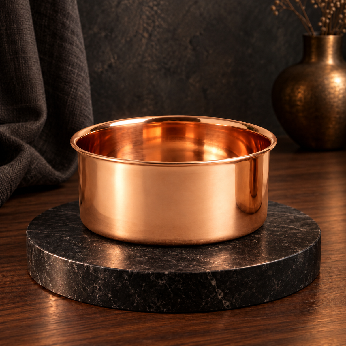DUNE polished smooth copper pet water bowl displayed on a black marble stand