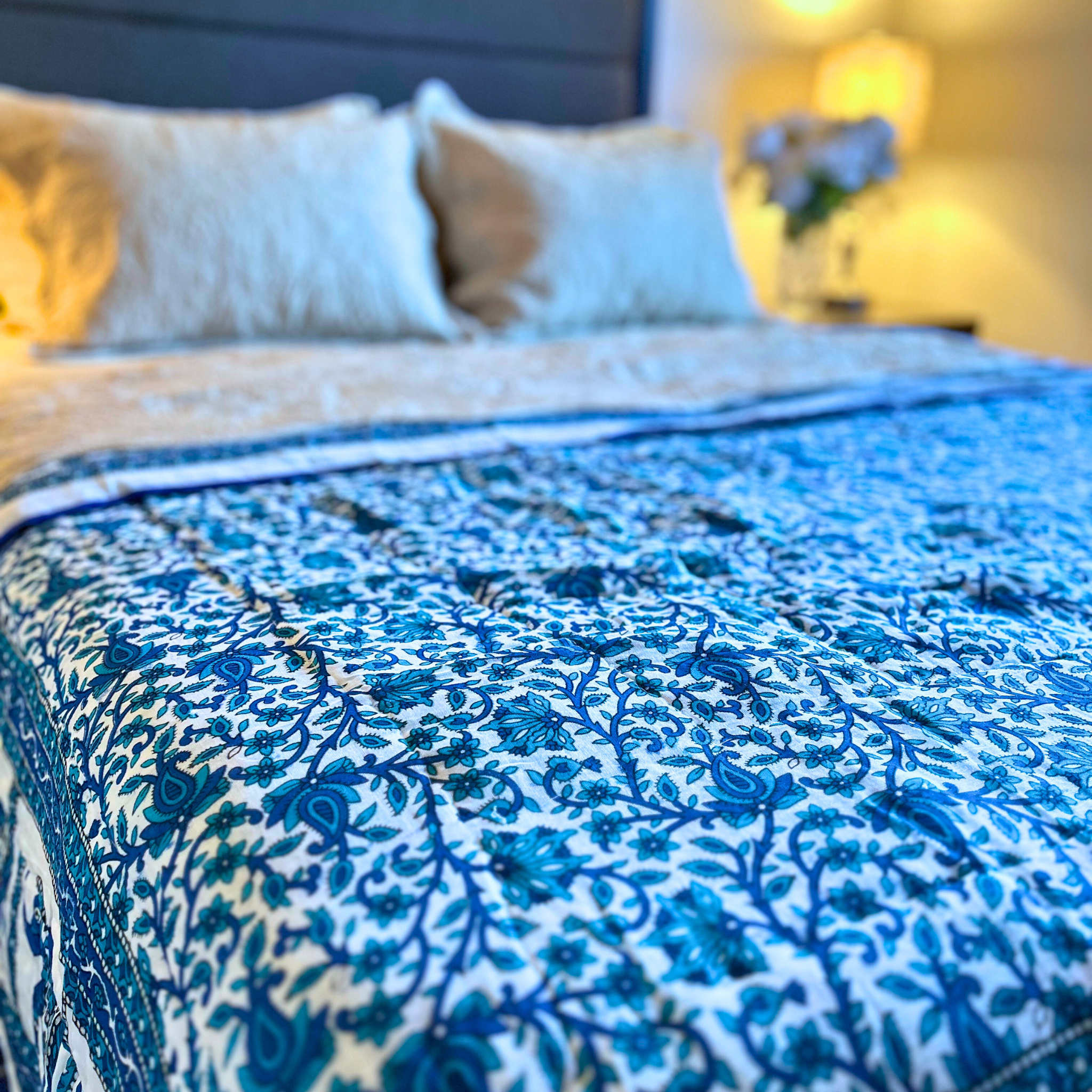 Handcrafted Jaipuri floral reversible cotton quilt with blue elephant border.