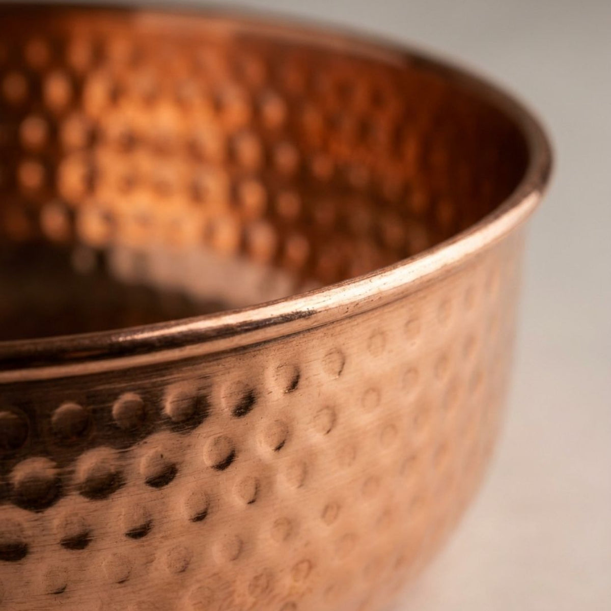 Close-up detail of AURORA's hand-hammered copper texture