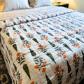 Vibrant orange and green Jaipuri quilt with a reversible design.