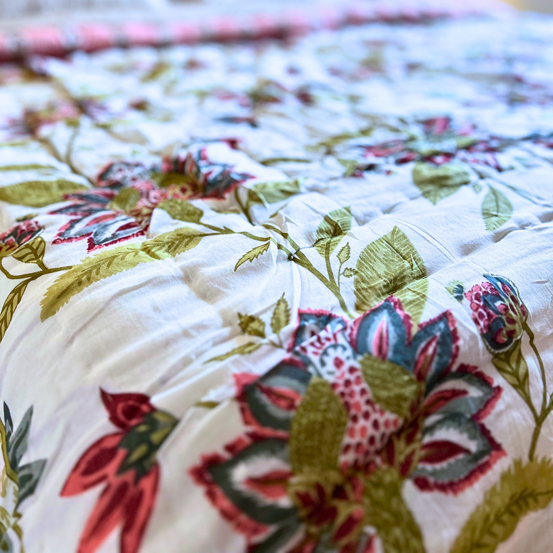 Reversible Jaipuri floral cotton quilt in green and red.