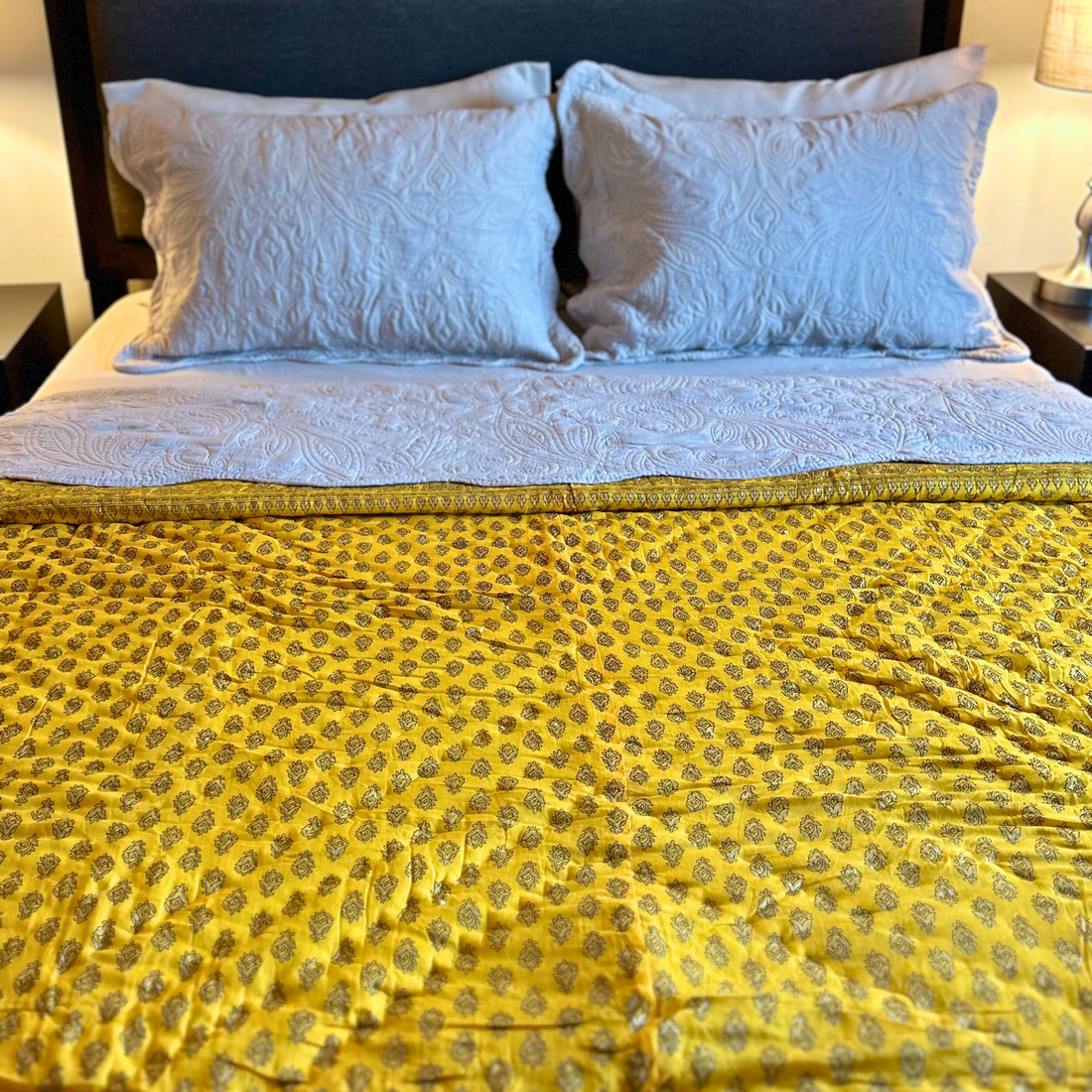 Handcrafted Jaipuri floral print reversible quilt in yellow.