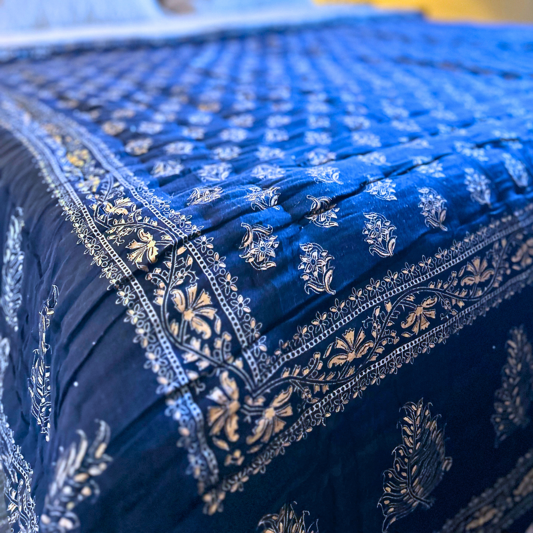 Block printed Jaipuri reversible cotton quilt in deep blue.