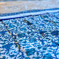 Elegant Jaipuri reversible quilt featuring floral print and blue elephant border.