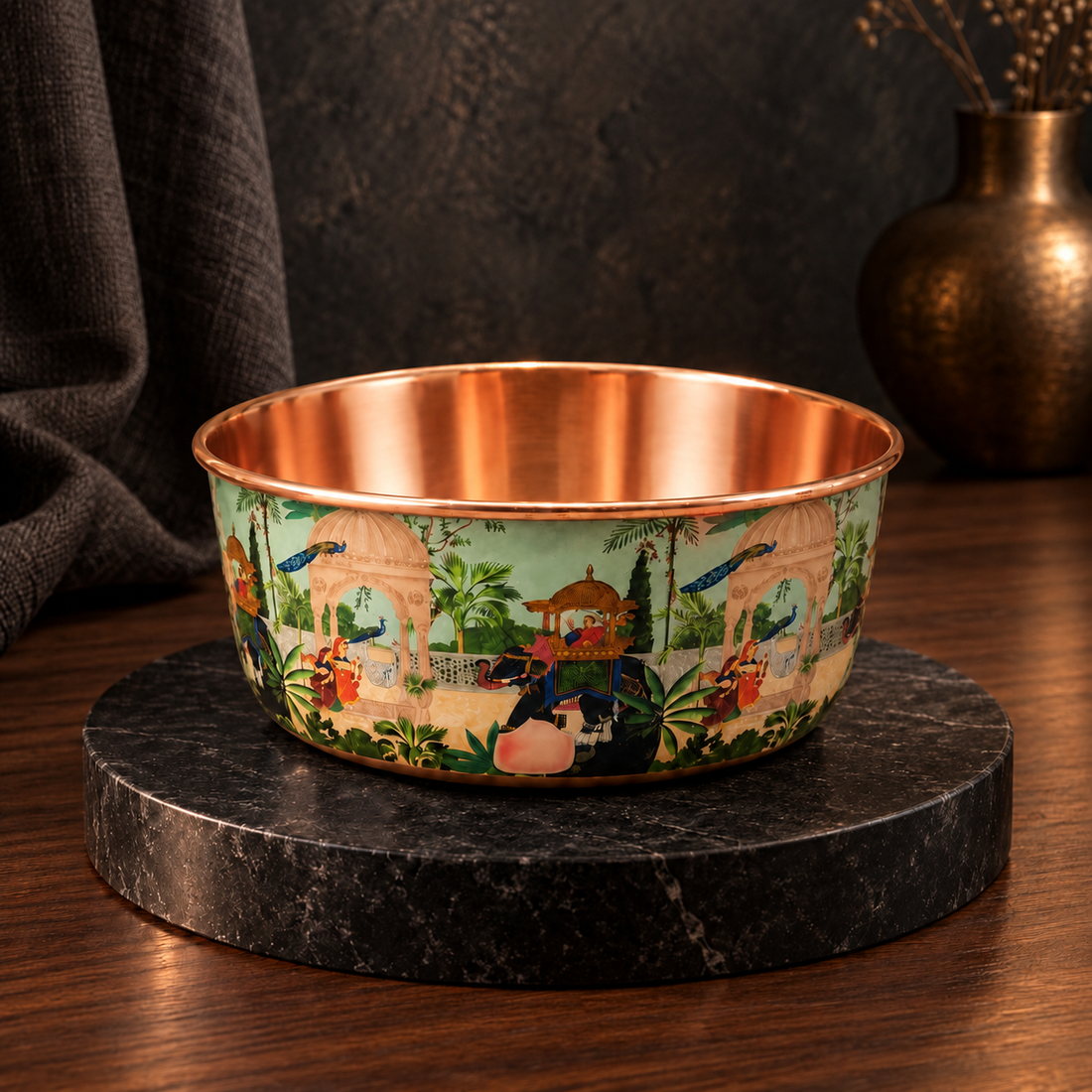 PALACE handcrafted copper pet water bowl with hand-painted peacock and elephant pattern, displayed on a black marble stand