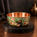 PALACE handcrafted copper pet water bowl with hand-painted peacock and elephant pattern, displayed on a black marble stand