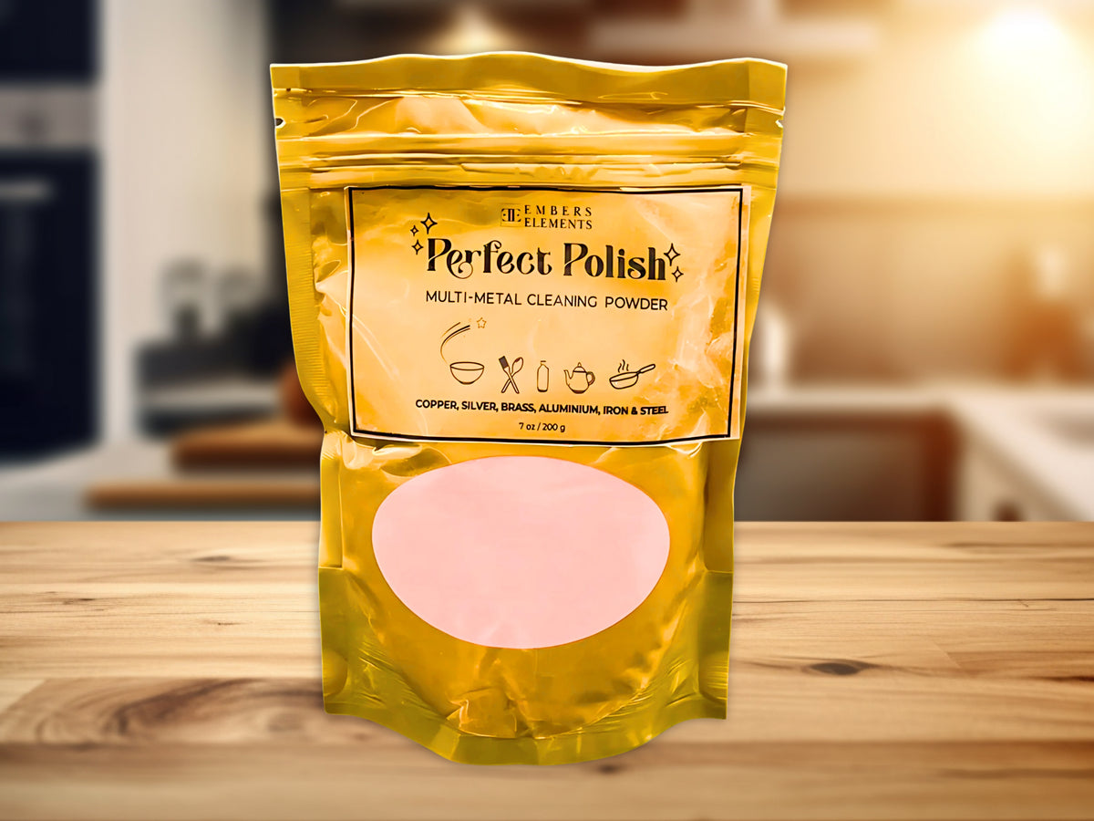 Perfect Polish multi-metal cleaning powder packaging on a wooden surface with a blurred kitchen background