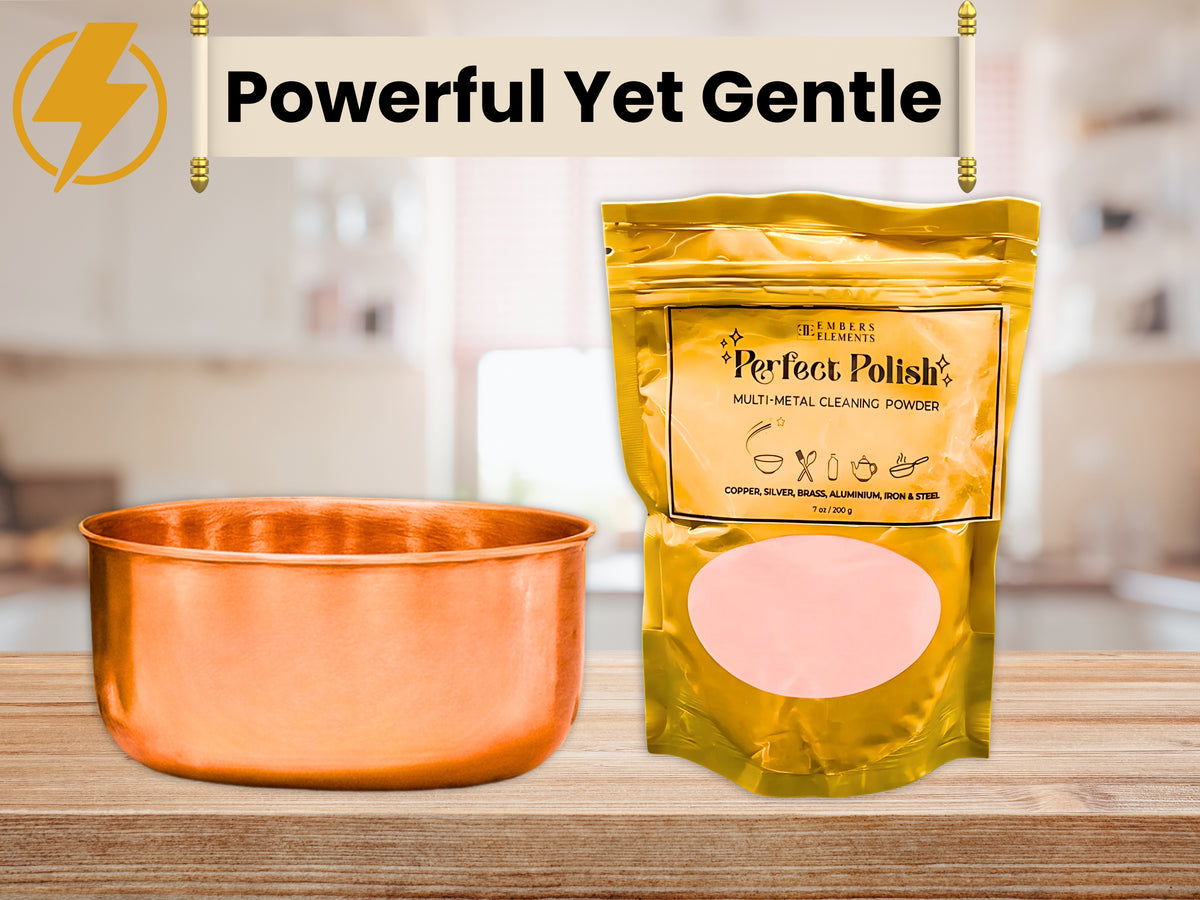 Copper pet bowl and Perfect Polish cleaner packaging on a wooden surface