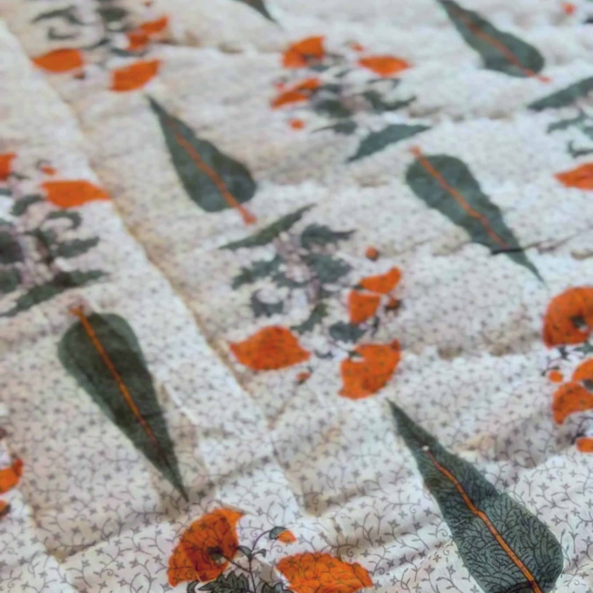 Vibrant orange-green cotton quilt Jaipuri reversible.